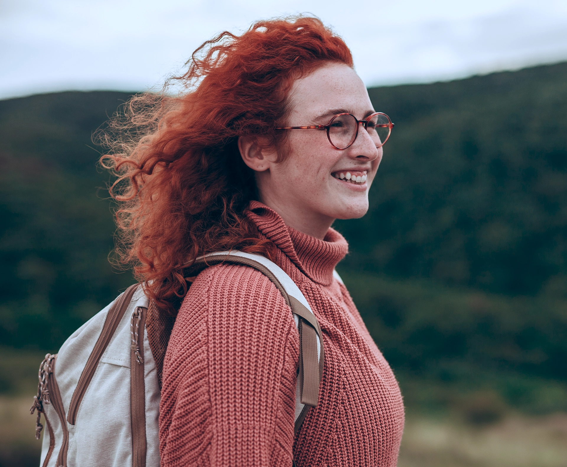 Red-haired woman wearing a backpack